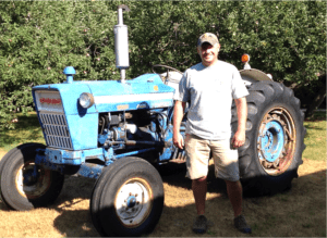 Man standing in front of tractor